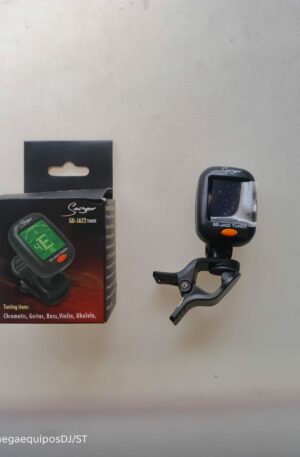 Afinador digital de clip marca Sniger modelo GD-JA22 con botón naranja, junto a su caja original sobre fondo claro.